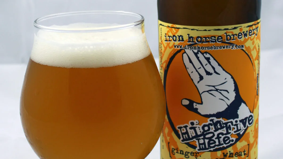 High Five glass and bottle Glass of High Five Hefe beer next to its bottle